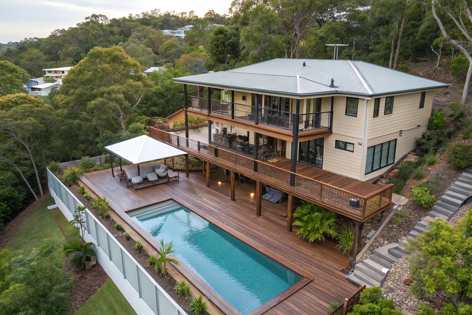 Multi-level deck extension with pool integration showing seamless material matching, Sunshine Coast