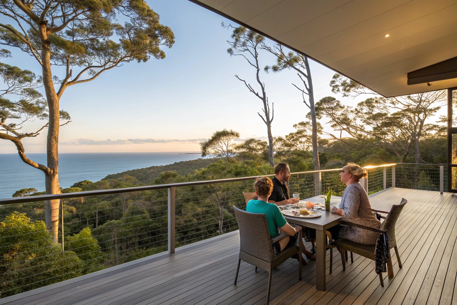 Family enjoying elevated deck outdoor entertaining with coastal views on Sunshine Coast high-set home