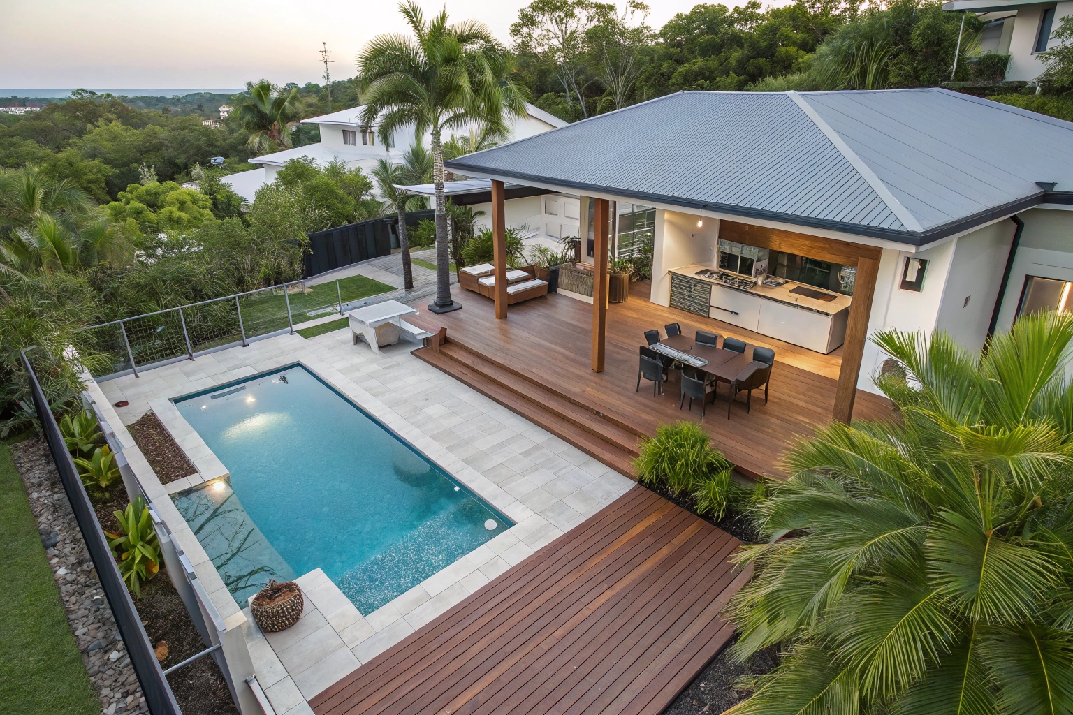 Ground-level deck seamlessly integrated with pool area, creating cohesive outdoor entertainment space