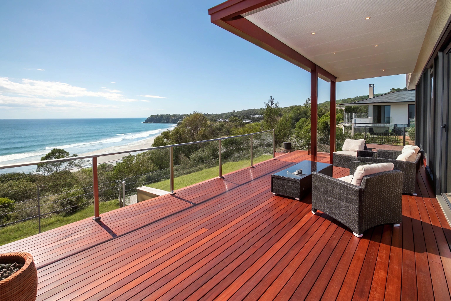 Merbau deck construction, Sunshine Coast, showing rich red timber with coastal views