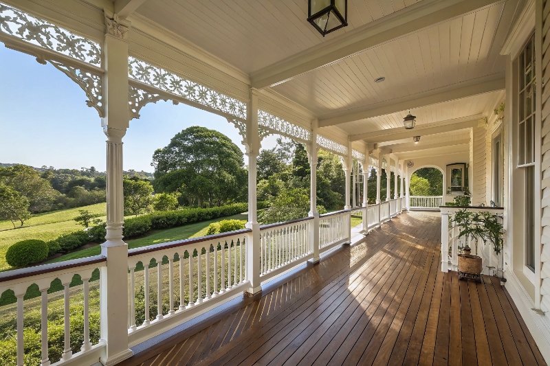 Traditional Queenslander verandah building Sunshine Coast with white timber posts and decorative fretwork