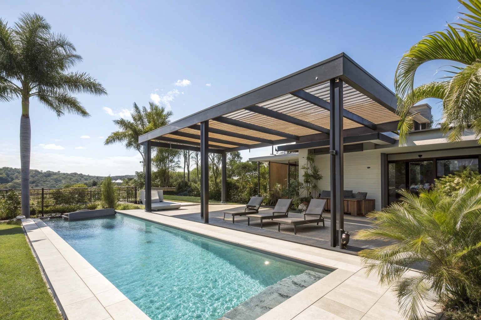 Contemporary pergola structure next to a sparkling swimming pool in Australian setting, lounge chairs beneath pergola for shade
